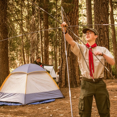 Lone scout setting up tent