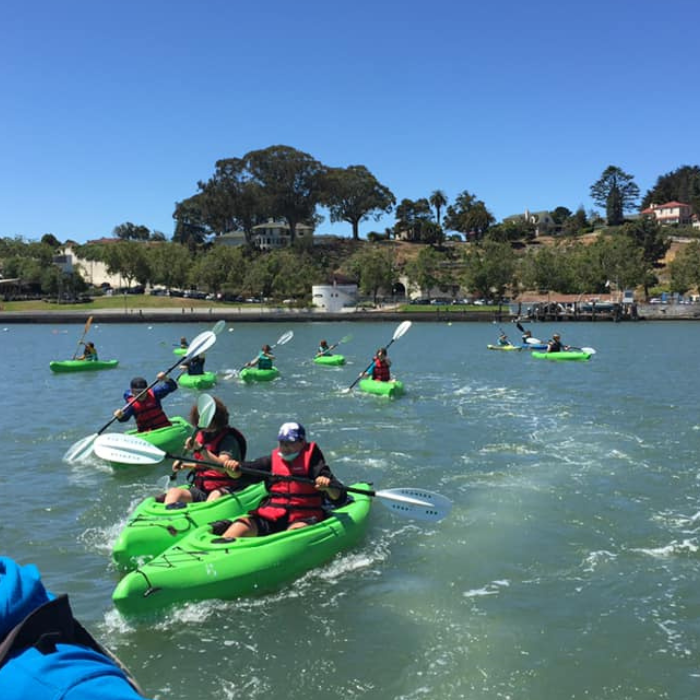 Scouts Kayaking in Green Kayaks